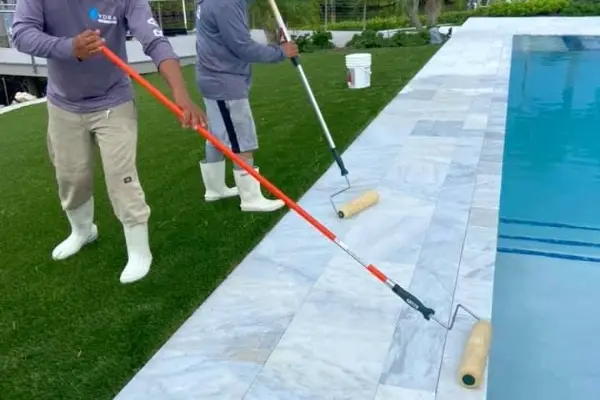 Seal Coat Being Applied To Pool