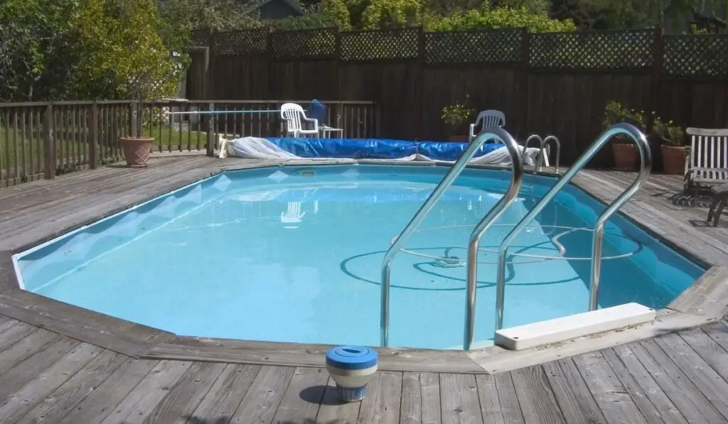 An above ground Doughboy swimming pool surrounded by decking