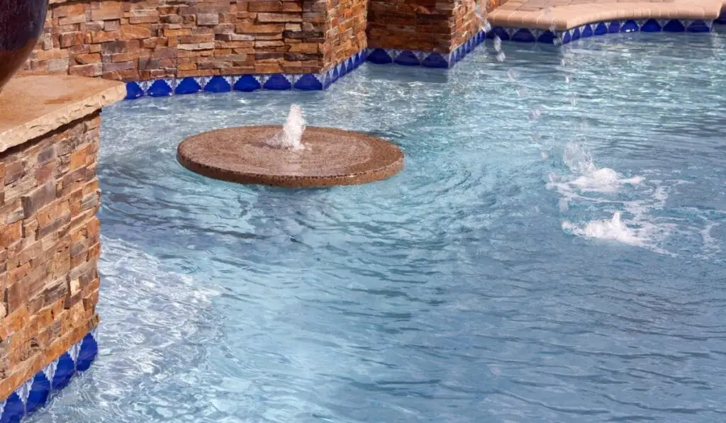 Floating fountain within a swimming pool