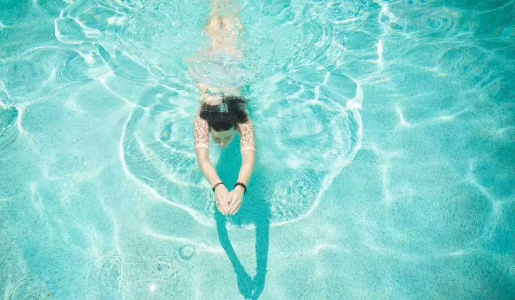 Woman Swimming in Pool 