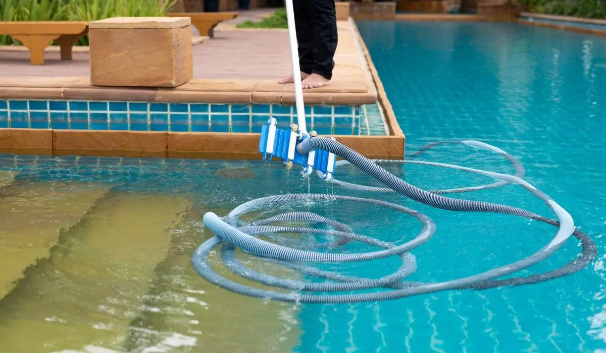 Worker cleaning swimming pool