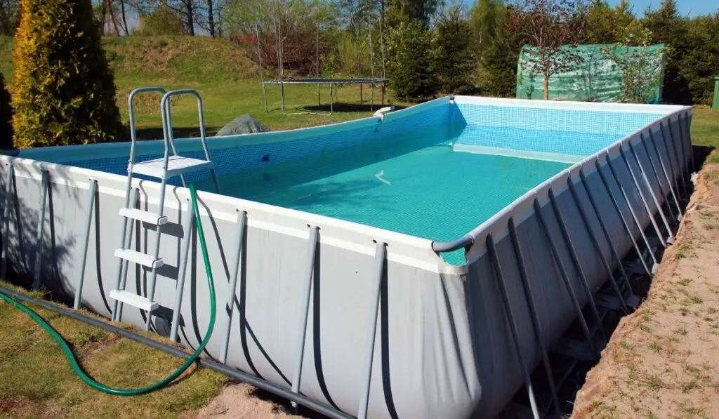 Empty above ground swimming pool in a backyard