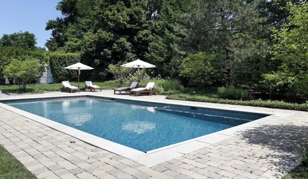 Swimming pool with deck chairs