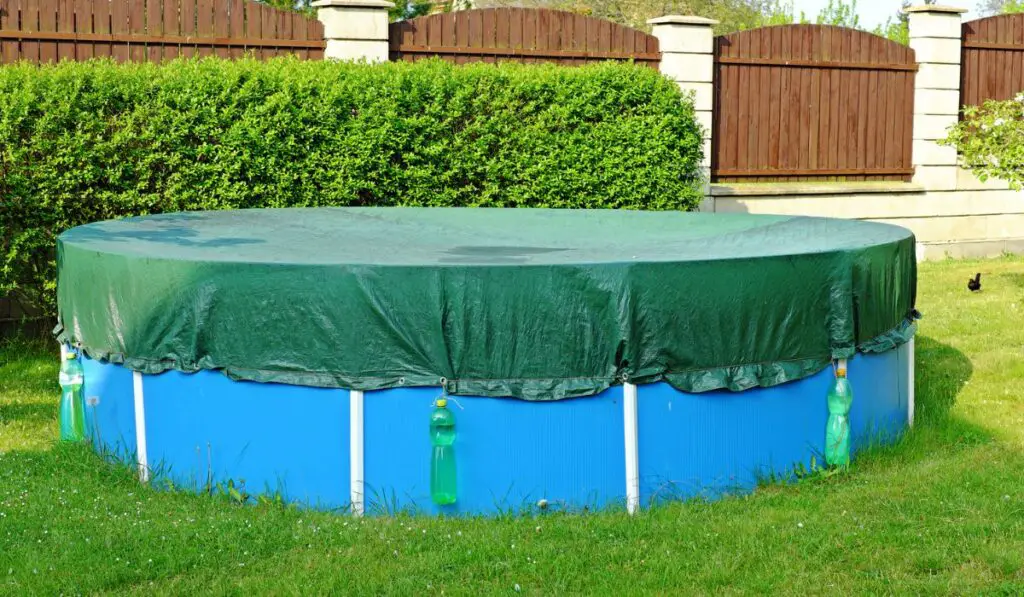 Garden swimming pool with swimming sail after winter 