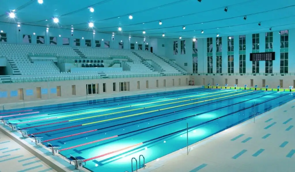 Interior details of lanes and seating in Olympic sized swimming pool 