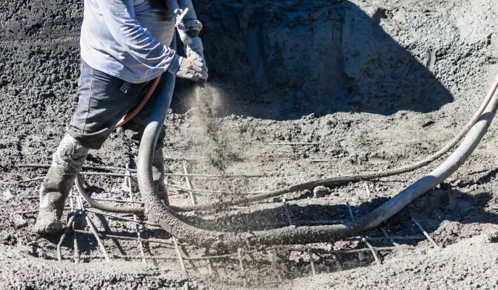 Pool Construction Worker Shooting Concrete