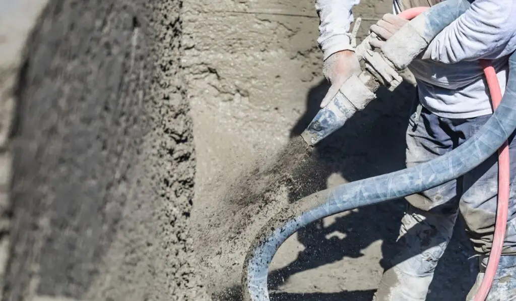 Pool Construction Worker Shooting Concrete 