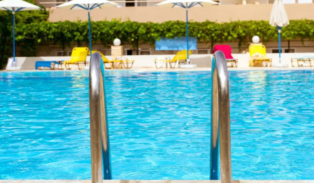 Metal hand railing of staircase to public swimming pool 