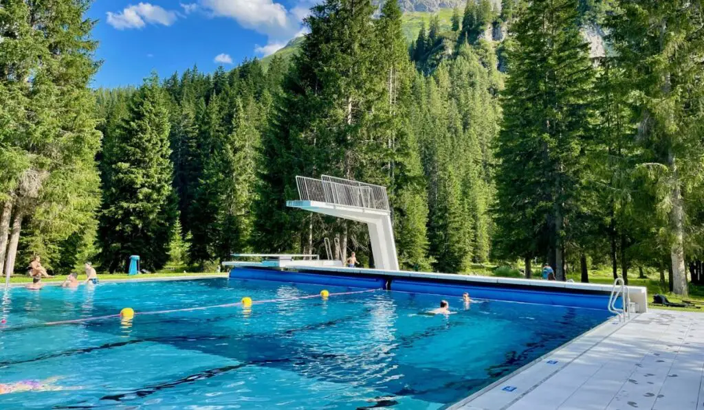 Panoramic view of idyllic public swimming pool in Lech am Arlberg
