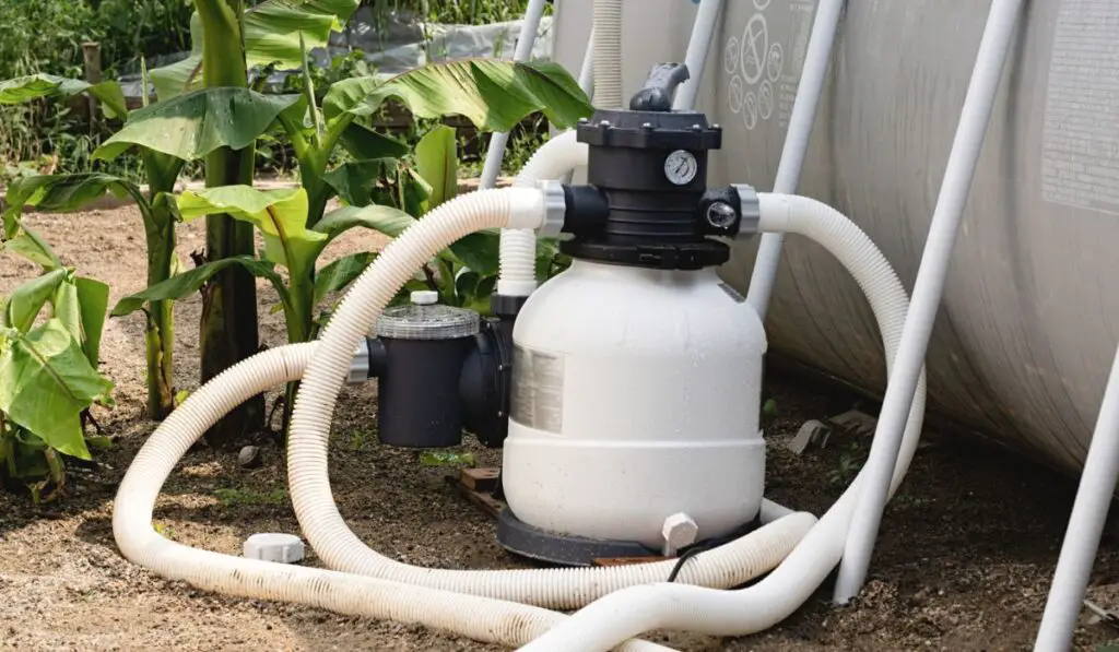 Sand filter plant at a pool in the garden 