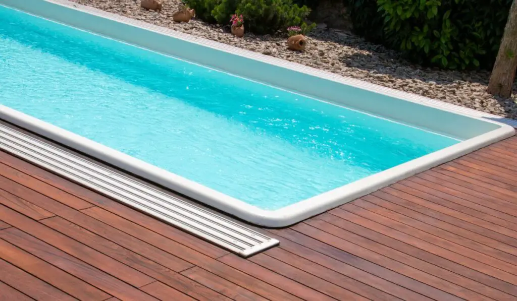 Swimming pool with teakwood flooring stripes summer vacation 