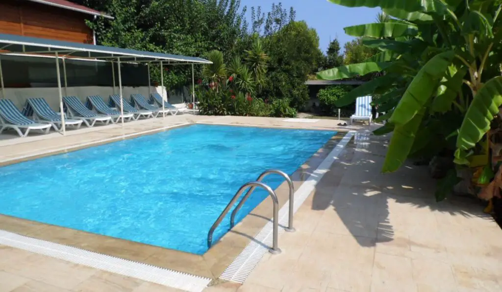 Tropical swimming pool with clear blue water 