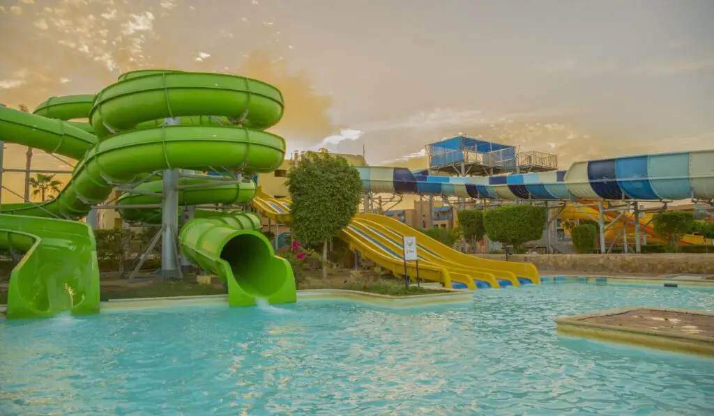 Colourful plastic slides in aquapark in the sunset