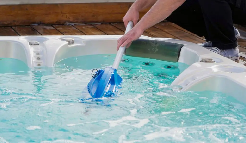 Hotel staff worker cleaning the hot tub