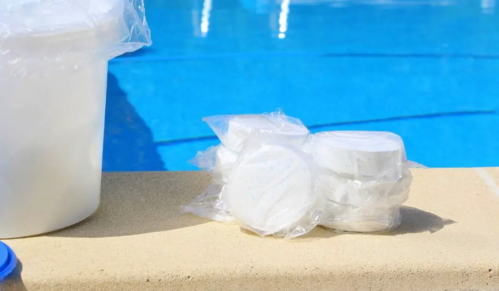 Large white chlorine tablet for pool disinfection in a transparent package