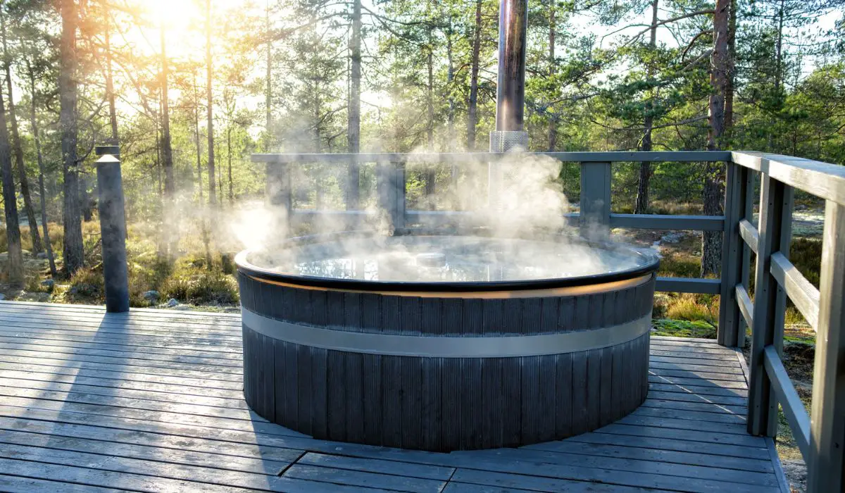 Modern big barrel outdoor hot tub in the middle of forest
