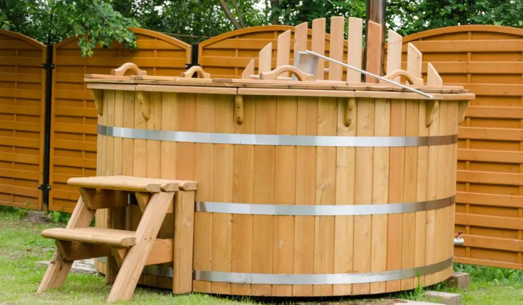 Modern wooden water hot tub with stairs outdoor 