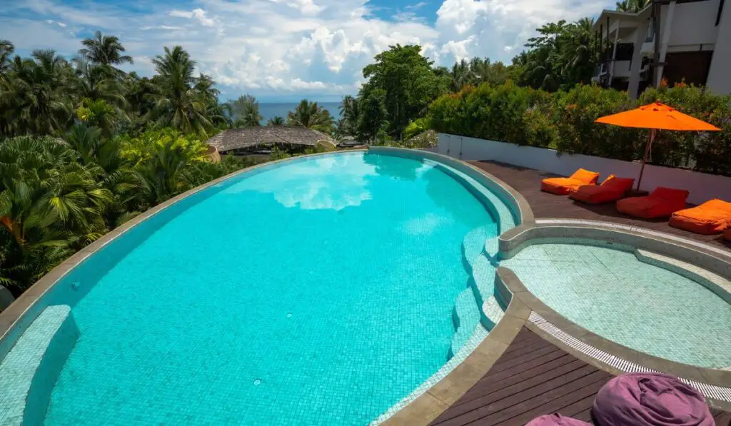 Swimming Pool with the sunbed and umbrella 