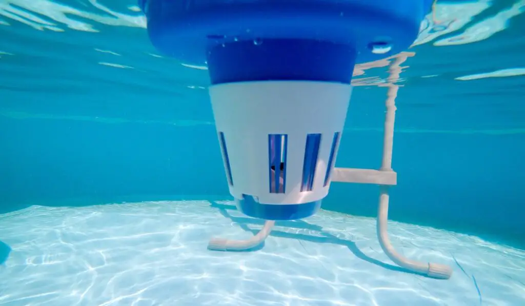 Underwater view of a chlorine dispenser in a swimming pool 