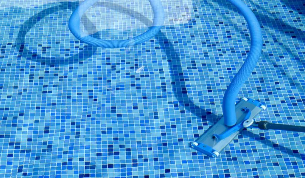 Vacuum cleaner on swimming pool 
