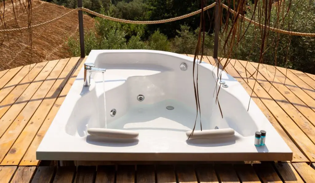 Hot tub in the hotel room suite balcony with sea view