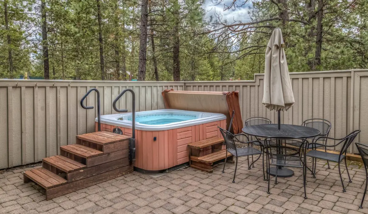 Hot tub on a paver patio with table and chairs