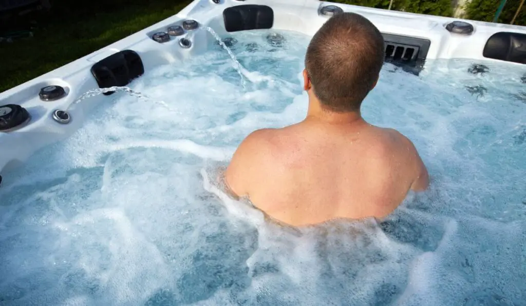 Man having massage in hot tub spa 