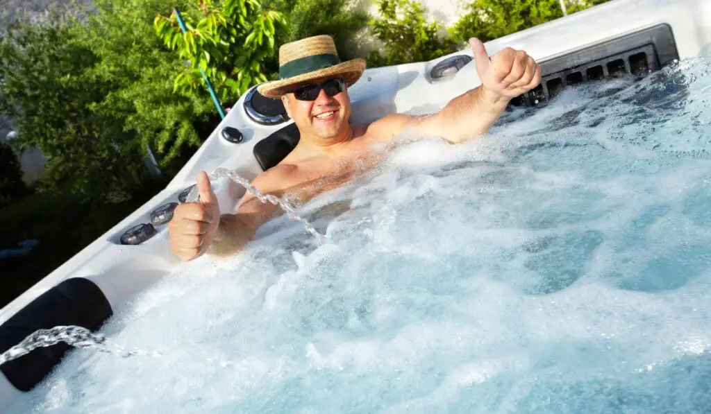 Man having massage in hot tub spa