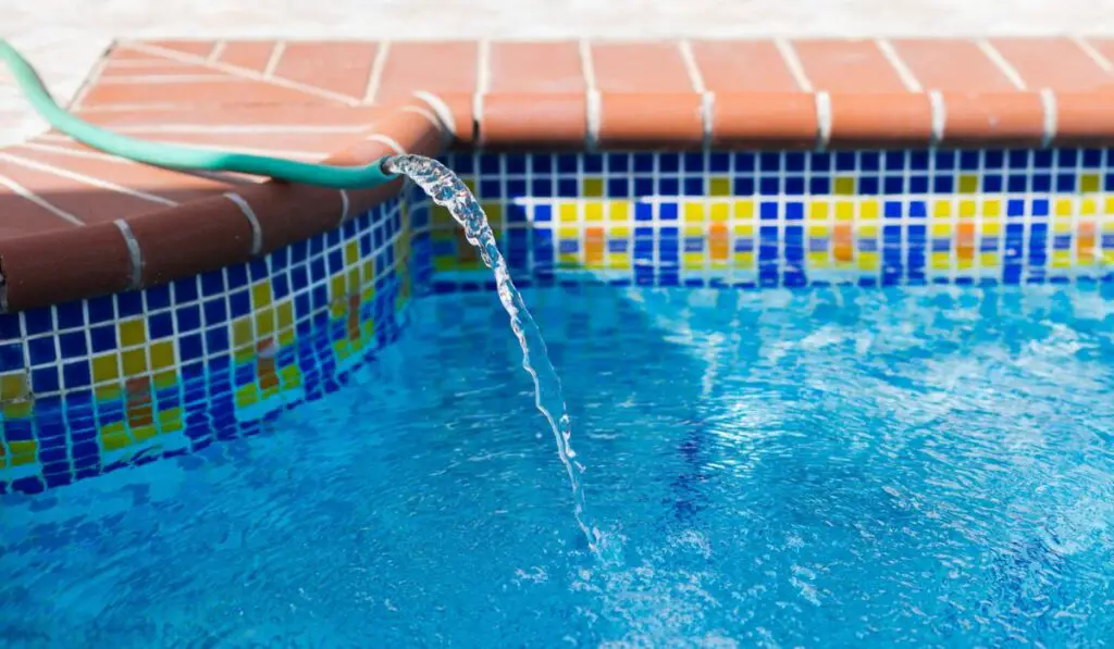 Water pipe filling up swimming pool