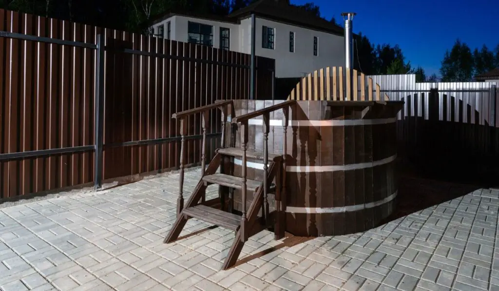 Rural wooden water hot tub with stairs garden yard