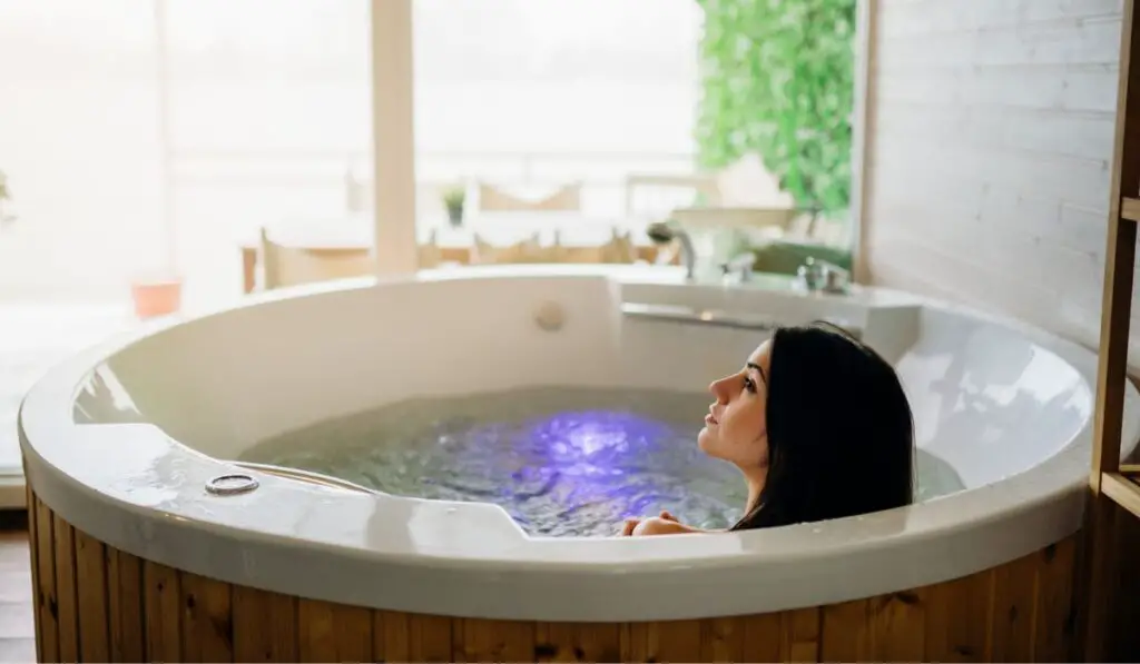 Woman having a spa day moment in modern bathroom indoors