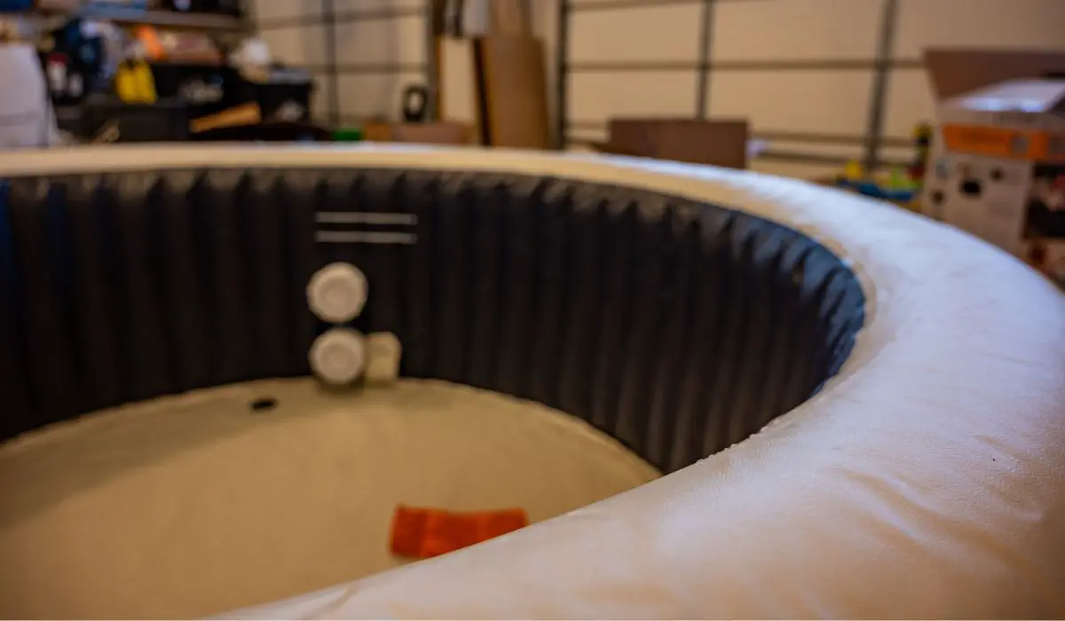 Filling an inflatable indoor hot tub inside a residential garage