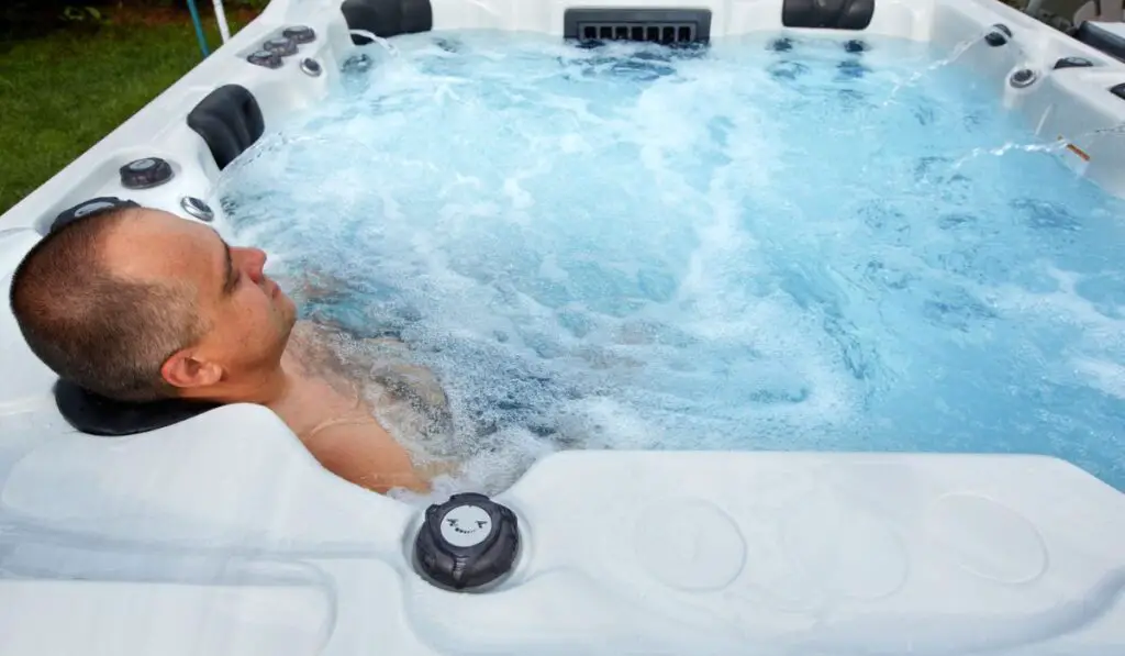 Man having massage in hot tub spa