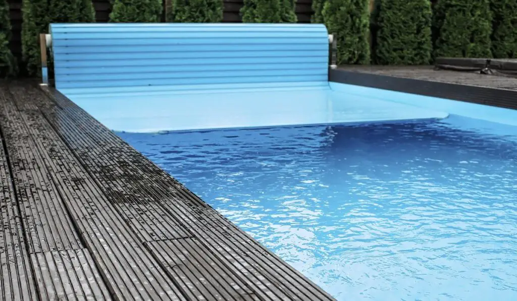 Automatic swimming pool covering system