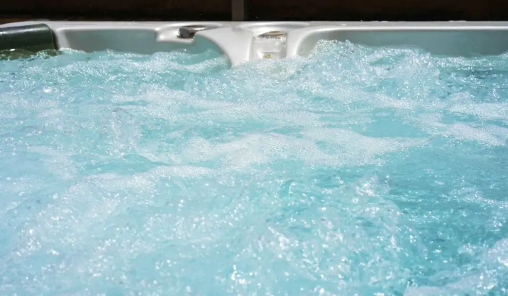 Hotel staff worker cleaning hot tub