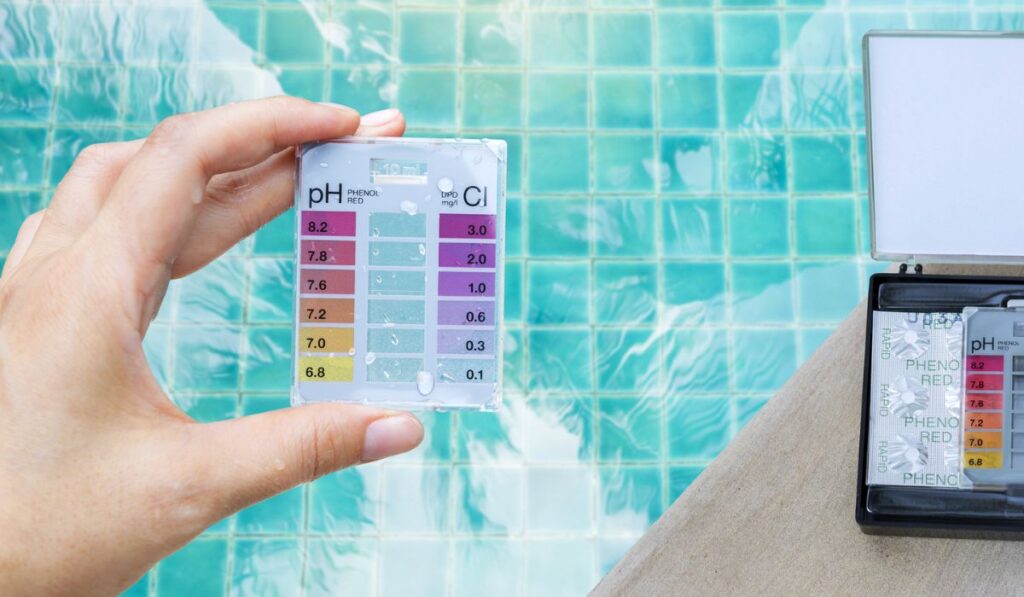 Water test kit in girl hand with Tablet water testing test kit on swimming pool edge
